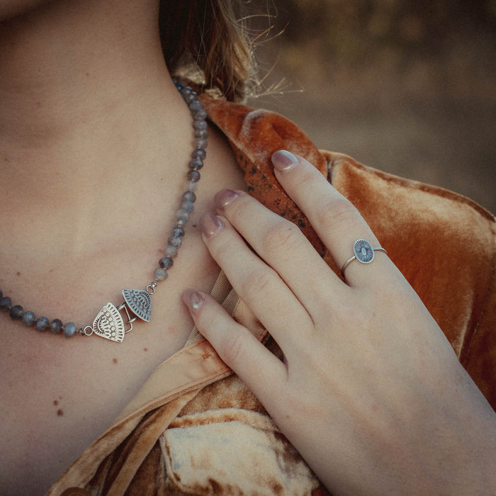 A model wearing the after the ring stamped silver stacking ring