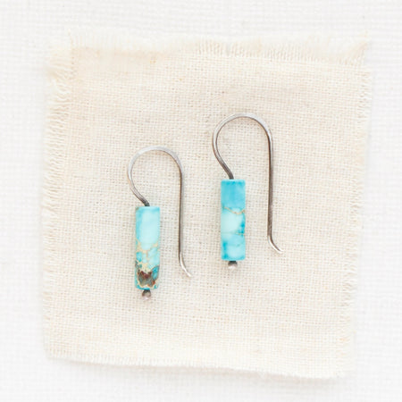 The sydney sea sediment jasper lobe hugger earrings styled on tan linen