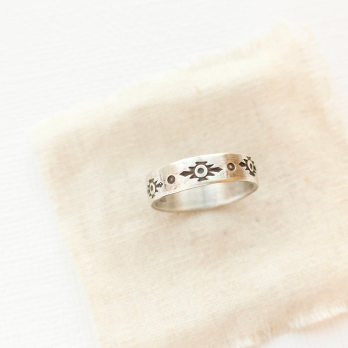 The stamped reno ring styled on tan linen