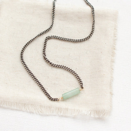 The sydney green aventurine tube necklace styled on tan linen