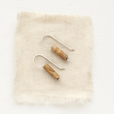 The picture jasper lobe hugger earrings styled on tan linen.