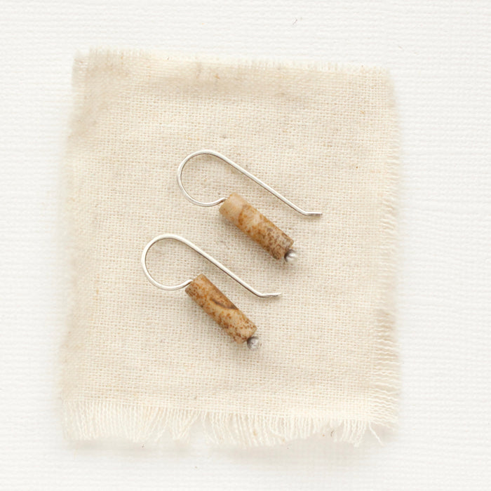 The picture jasper lobe hugger earrings styled on tan linen.
