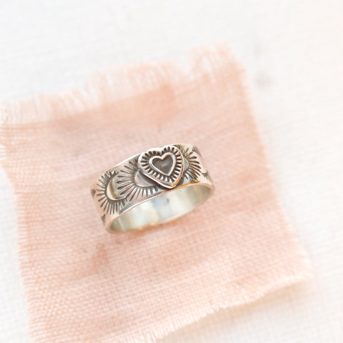 The layered heart silver band ring styled on pink linen