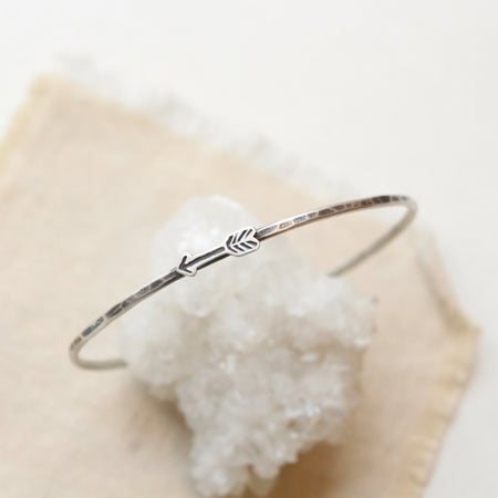 Hand Forged Arrow Bangle Bracelet on crystal display