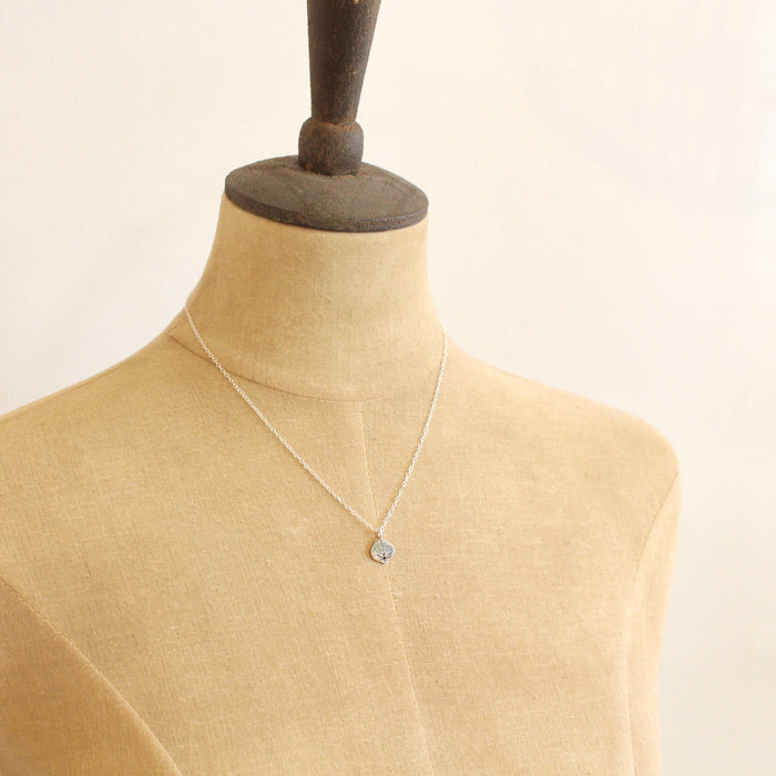 Mannequin wearing stamped silver aspen leaf necklace