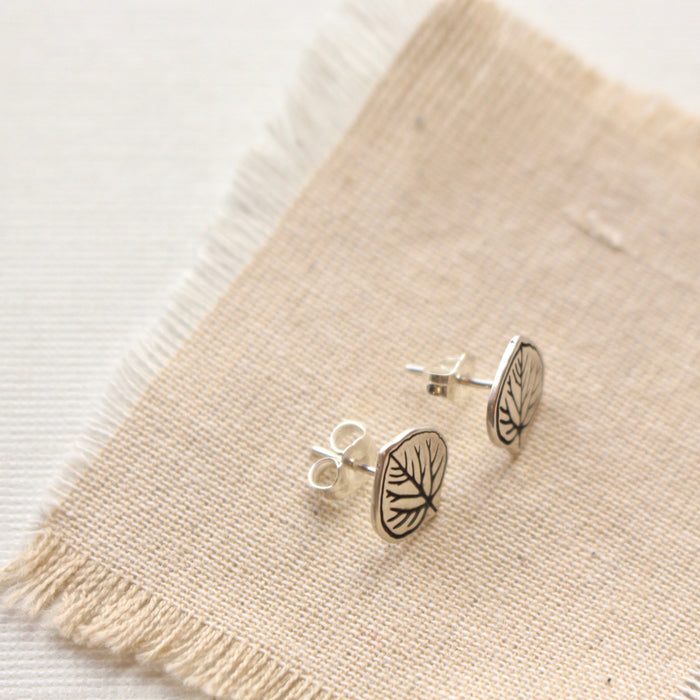 Stamped silver aspen leaf post earrings showing butterfly earring backs