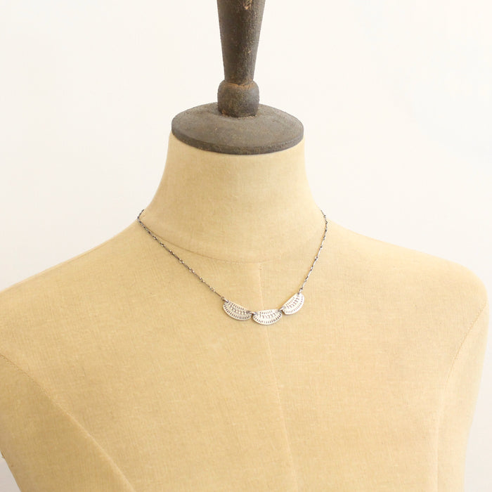 The asmi trio collar necklace styled on a mannequin to show the length