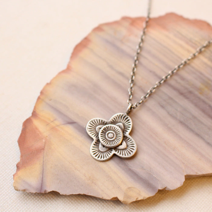 The layered talara necklace styled on a striped rock