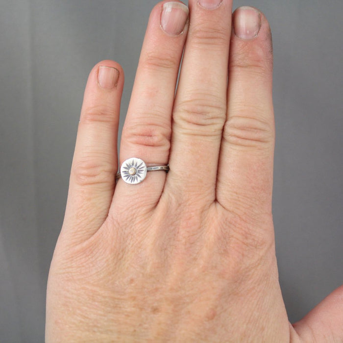 The little sun mixed metal ring styled on a hand to show size reference