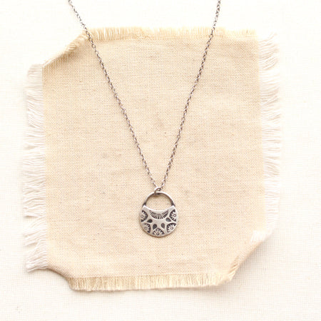 midnight bloom necklace on tan linen