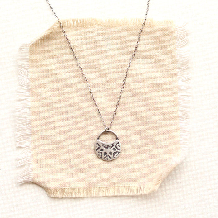 midnight bloom necklace on tan linen
