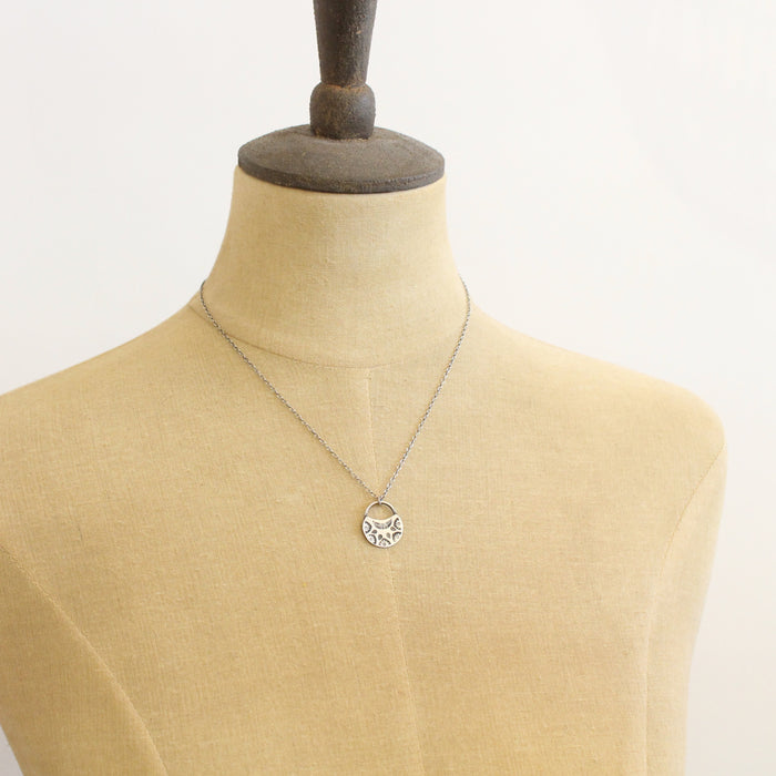 A mannequin wearing the midnight bloom necklace