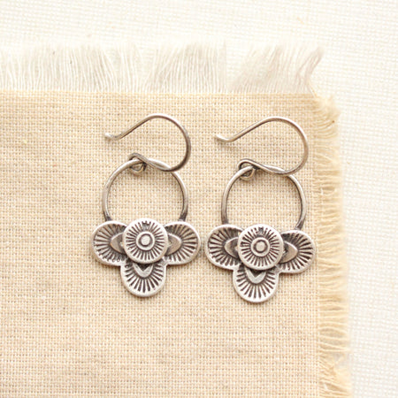 Layered talara loop earrings on tan linen
