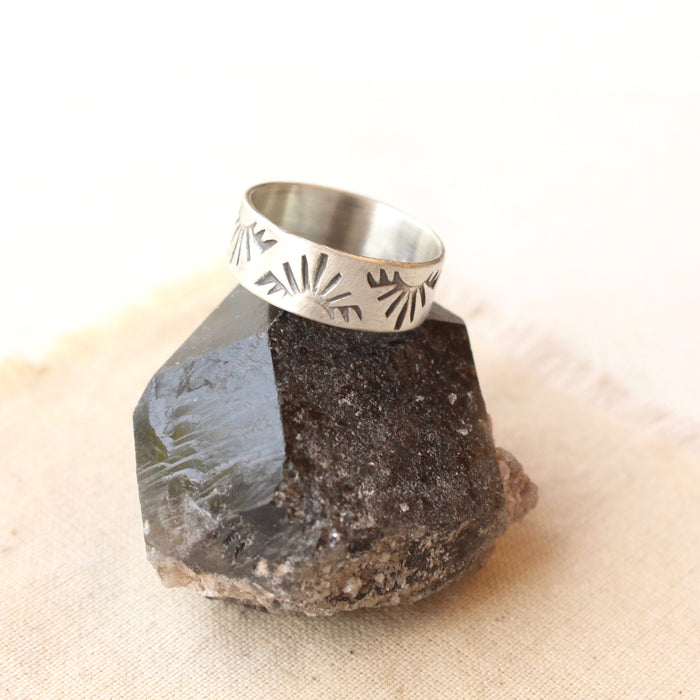The sunrise hawk band ring is styled on a black crystal