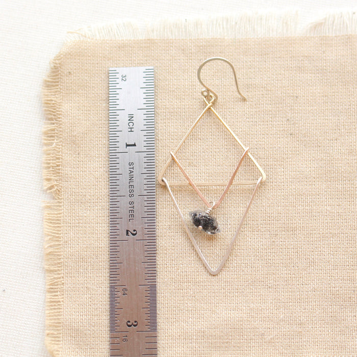 A triple triangle herkimer diamond earring next to a ruler for size reference