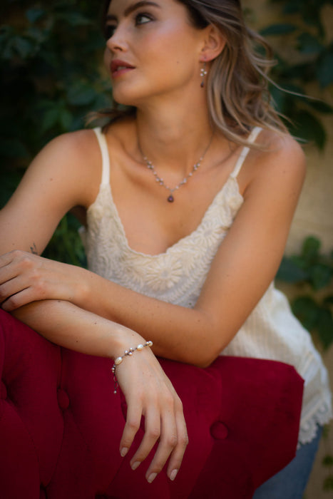 A model wearing the wrapped pearl bud vine bracelet in silver