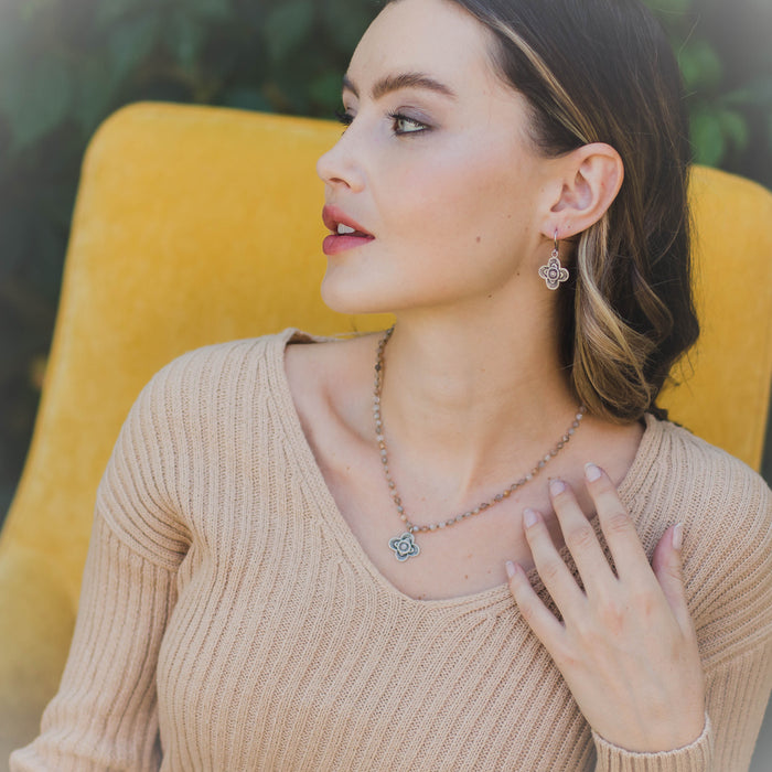 A model wearing the layered talara earrings