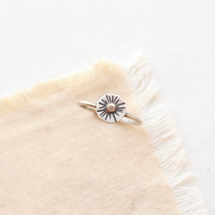 The little sun mixed metal ring styled on tan linen