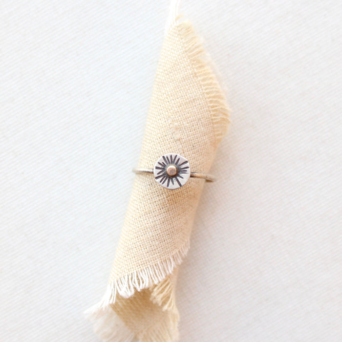 The little sun mixed metal ring styled on tan linen