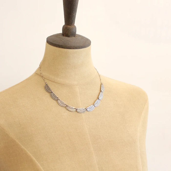 The asmi full collar necklace styled on a mannequin to show the length