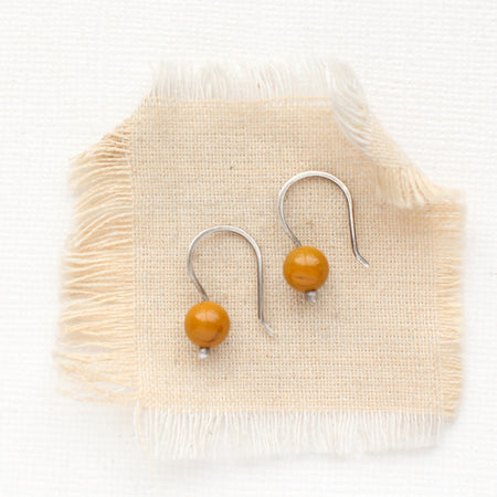 The mookaite lobe hugger earrings styled on tan linen
