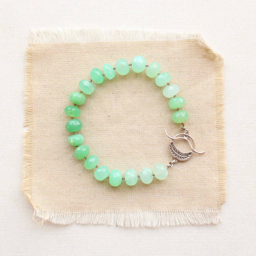 The chrysoprase and stamped silver bracelet styled on tan linen
