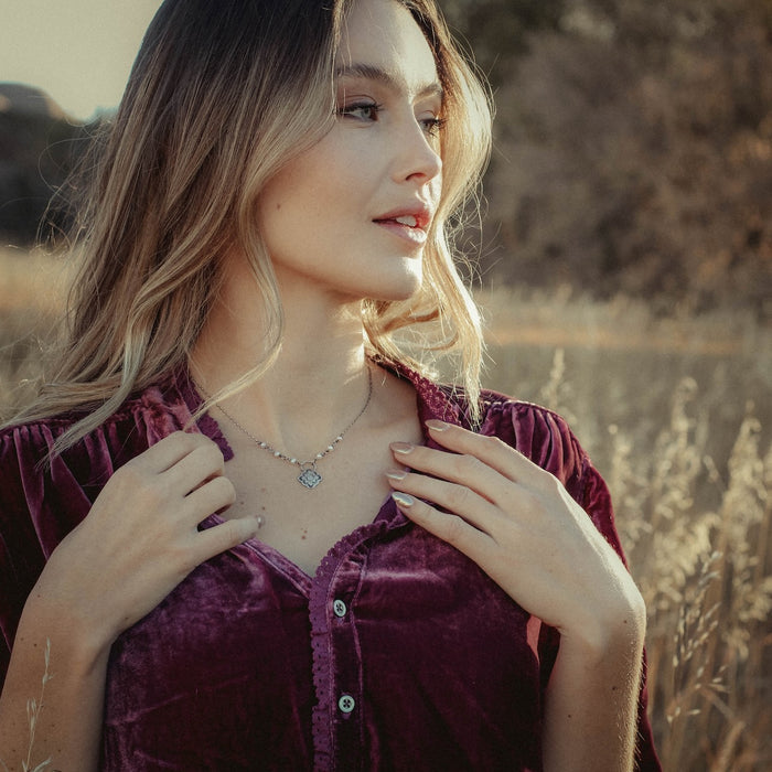 Model wearing the sterling silver talara bloom necklace with pearls