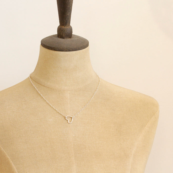 A mannequin wearing the floating silver heart necklace