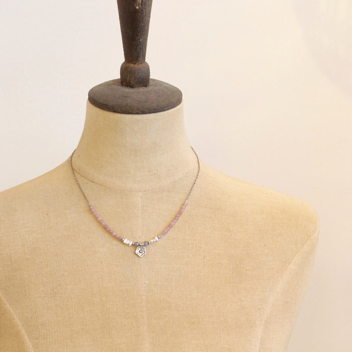 The blush mini cactus flower necklace styled on a mannequin to show the length