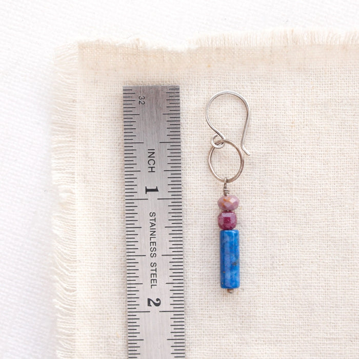 an alpine bloom sydney hoop earring next to a ruler for size reference