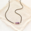 The sydney lepidolite necklace styled on tan linen