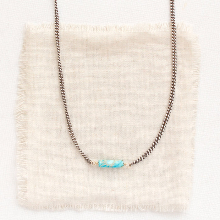 the sea sediment jasper necklace styled on tan linen