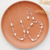 The bright silver wrapped pearl bud vine set styled on an orange plate with dried grass