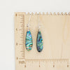 The abalone and herkimer diamond earrings on a wooden ruler for size reference