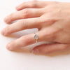 A hand wearing the alpine glow tacking ring