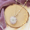 The amethyst stalactite flower necklace styled on wood with purple velvet and dried grass