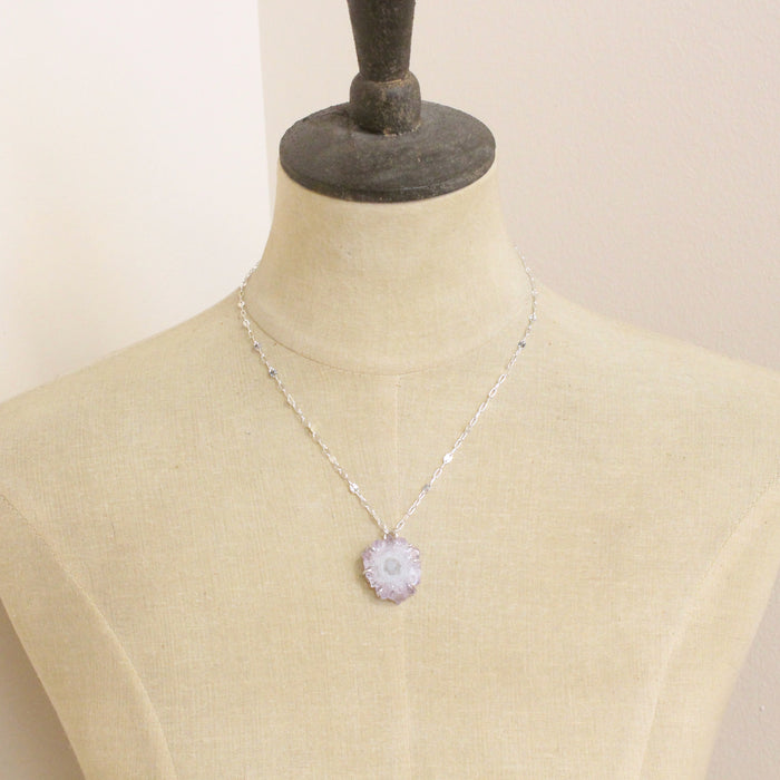 A mannequin wearing the amethyst stalactite flower necklace