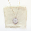 The amethyst stalactite flower necklace styled on tan linen