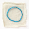 The apatite stretch bracelet styled on tan linen
