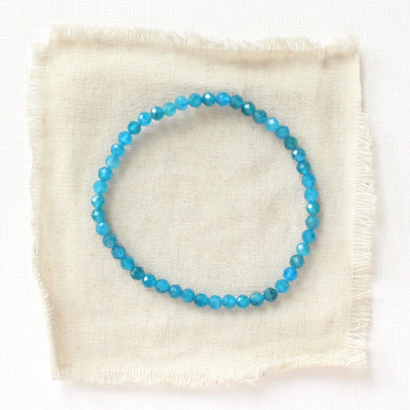 The apatite stretch bracelet styled on tan linen