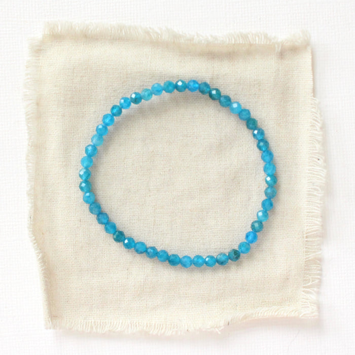 The apatite stretch bracelet styled on tan linen