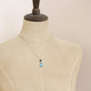 A mannequin wearing the apatite and turquoise drop necklace