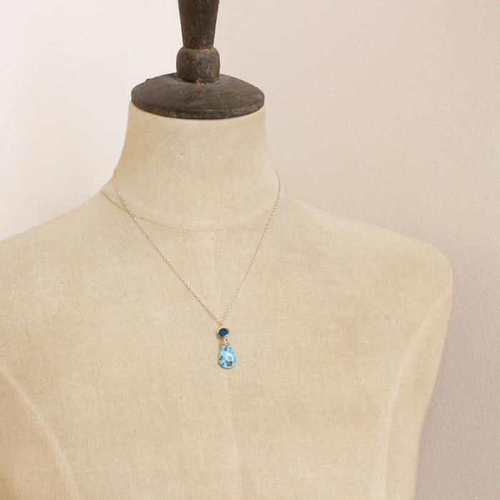 A mannequin wearing the apatite and turquoise drop necklace