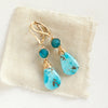 The apatite and turquoise drop earrings styled on tan linen
