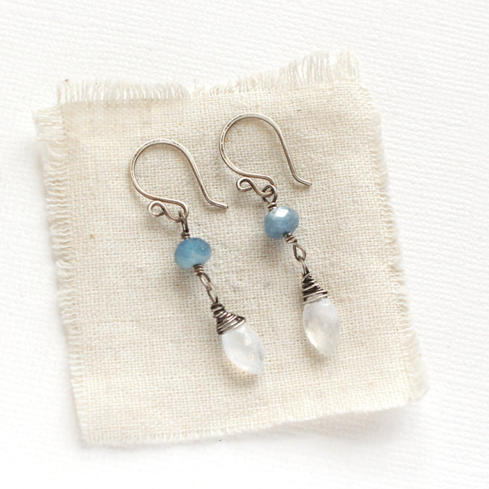 The aquamarine and moonstone earrings styled on tan linen