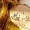 The aspen leaf ring styled on wood with yellow velvet