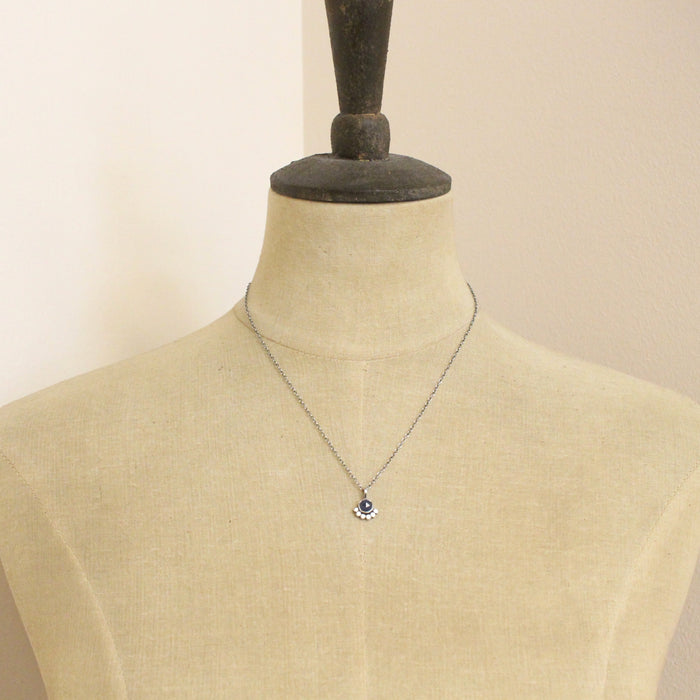 A mannequin wearing the beaded sapphire necklace