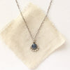 The beaded sapphire necklace styled on tan linen