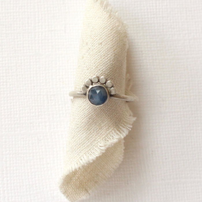 The beaded sapphire ring styled on rolled tan linen