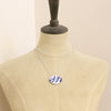 A mannequin wearing the birds of a feather vintage plate necklace